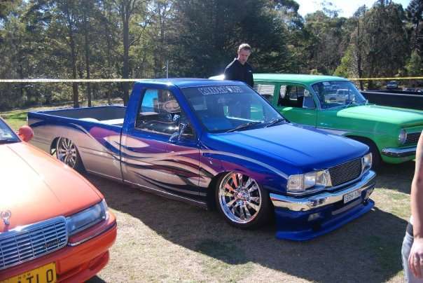 Metallic blue custom minitruck with purple flame graphics and chrome wheels at Day on the Green 2009