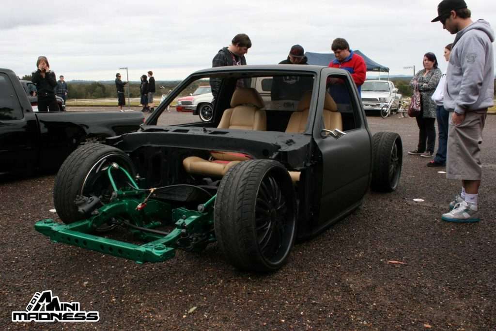 Matte black custom minitruck with tan interior and exposed bright green frame at Mini Madness 2011